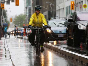 A cyclist uses the bike lane on Laurier Avenue.