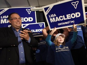 Joe Varner (l), husband of Ontario Progressive Conservative candidate Lisa MacLeod, and daughter Victoria, cheer in support of MacLeod, who won her Nepean-Carleton riding, at the Royal Canadian Legion branch in Ottawa on Oct. 6, 2011.