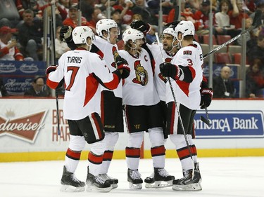 Ottawa Senators left wing Clarke MacArthur, fourth from left, celebrates with teammates after his goal against the Detroit Red Wings in the third period of an NHL hockey game in Detroit Tuesday, March 31, 2015. Ottawa won 2-1 in a shootout.
