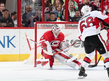 Mike Hoffman #68 of the Ottawa Senators fires a shot on Anton Khudobin #31 of the Carolina Hurricanes.