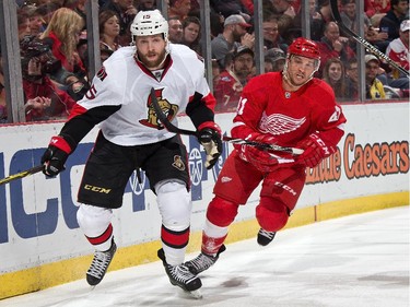 Luke Glendening #41 of the Detroit Red Wings tries to skate by Zack Smith #15 of the Ottawa Senators.