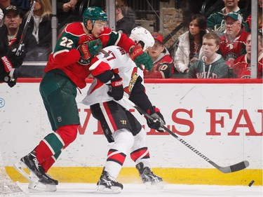 Nino Niederreiter #22 of the Minnesota Wild is called for a holding penalty against David Legwand #17 of the Ottawa Senators.