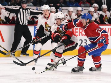 Jean-Gabriel Pageau #44 of the Ottawa Senators controls the puck while being challenged by Jeff Petry #26 of the Montreal Canadiens.