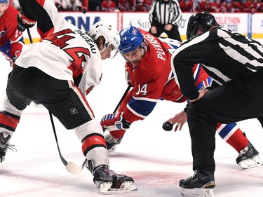 Tomas Plekanec #14 of the Montreal Canadiens Jean-Gabriel Pageau #44 of the Ottawa Senators face off.