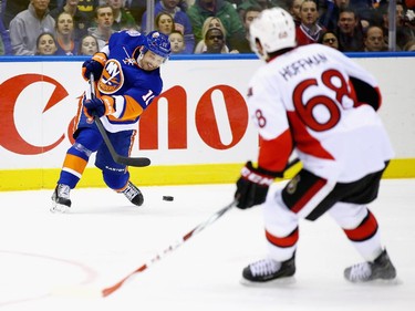 Lubomir Visnovsky #11 of the New York Islanders takes a slapshot against the Ottawa Senators.