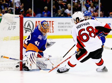 Jaroslav Halak #41 of the New York Islanders makes a save against Mike Hoffman #68 of the Ottawa Senators.