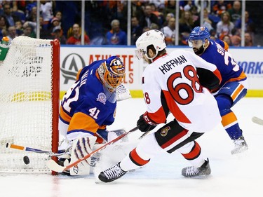 Jaroslav Halak #41 of the New York Islanders makes a save against Mike Hoffman #68 of the Ottawa Senators.