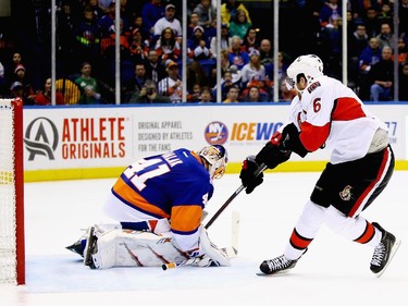 Jaroslav Halak #41 of the New York Islanders makes a save against Bobby Ryan #6 of the Ottawa Senators.