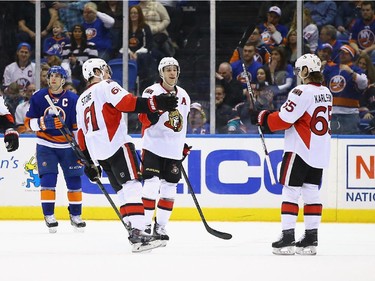 Matt Puempel #26 of the Ottawa Senators celebrates his goal with his teamates against the New York Islanders.