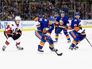John Tavares #91 of the New York Islanders skates with the puck against the Ottawa Senators.