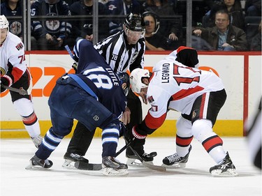 David Legwand #17 of the Ottawa Senators wins a first period face-off against Bryan Little #18 of the Winnipeg Jets.
