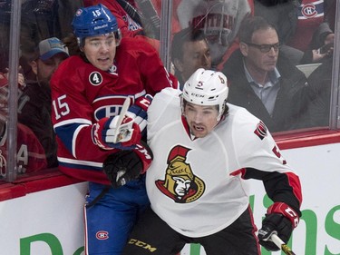 Montreal Canadiens' P.A. Parenteau, left, is checked into the baords by Ottawa Senators' Cody Ceci during first period NHL hockey action.