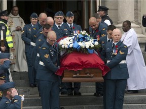 The casket of warrant officer Patrice Vincent leaves the church after funeral services Saturday, November 1, 2014 in Longueuil, Quebec. Vincent was run over and killed in what is being described as a terrorist attack last week.