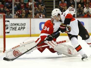 Detroit Red Wings goalie Petr Mrazek (34) stops a shot by Ottawa Senators right wing Mark Stone (61) in the first period.