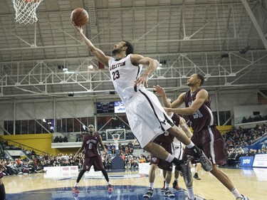 Carleton Ravens' Philip Scrubb scores against the Ottawa Gee-Gees during second half CIS basketball final action in Toronto on Sunday March 15, 2015.