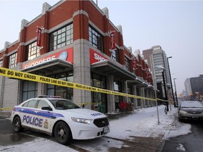 Police investigate reports of gunshots near Rideau and Nelson  streets, including placing police tape around the nearby Shoppers Drug Mart, March 8 2015.