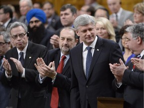 The Conservative caucus applauds as Prime Minister Stephen Harper unveils the next steps in the war against ISIL.