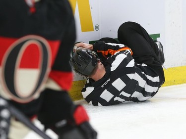 Referee Kelly Sutherland fell to the ice during first period NHL action.
