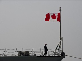 A Canadian soldier stands on board the HMCS Fredericton.