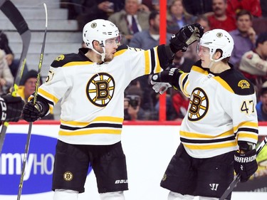 Ryan Spooner and Torey Krug, right, of the Boston Bruins celebrate Spooner's goal (and his team's third) against the Ottawa Senators during second period NHL action.