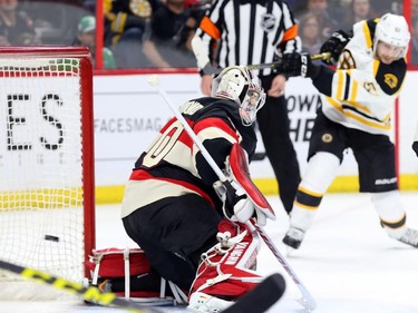 Ryan Spooner of the Boston Bruins scores on Andrew Hammond of the Ottawa Senators during second period NHL action.