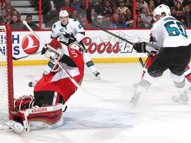 Chris Tierney #50 of the San Jose Sharks scores a second period goal on a backhand shot against Andrew Hammond #30 of the Ottawa Senators.
