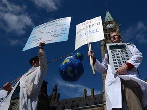 Scientists rally on Parliament Hill in Ottawa on Monday, September 16, 2013 as Canadian scientists and their supporters hold demonstrations across the country, calling on the federal government to stop cutting scientific research and muzzling its scientists. There are strict guidelines on when public servants can participate in political activity.