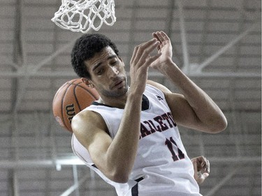 Carleton Ravens Thomas Scrubb scores on the Ottawa Gee-Gees during first half CIS basketball final action in Toronto on Sunday. March 15 , 2015.