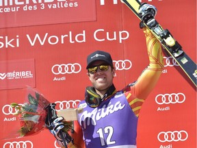 Ottawa's Dustin Cook celebrates on the podium after winning the Men's Super G race at the FIS Alpine Skiing World Cup finals in Meribel on March 19, 2015.