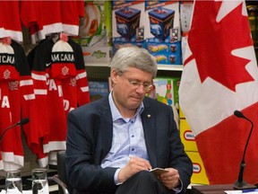 Canadian Prime Minister Stephen Harper participates in a roundtable discussion at a Canadian Tire Store in Mississauga, Ont., on Thursday, December 11, 2014. The discussion was attended by members of the Retail Council of Canada, as well as Joe Oliver, Minister of Finance, and Brad Butt, Member of Parliament for Mississauga-Streetsville.