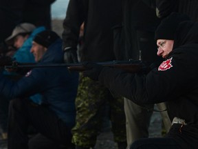 Prime Minister Stephen Harper shoots a .303 Lee Enfield rifle while taking part in demonstration from Canadian Rangers near the Artic community of Gjoa Haven, Nunavut on Tuesday, August 20, 2013.