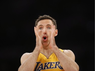 FILE - In this April 1, 2014, file photo, Los Angeles Lakers' Steve Nash communicates with teammate Pau Gasol, not pictured, against the Portland Trail Blazers during the first half of an NBA basketball game in Los Angeles. Nash has announced on Saturday, March 21, 2015, that he is retiring from the NBA.