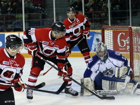 Sudbury Wolves goalie Troy Timpano makes a save on 67's forward Jeremiah Addison during second-period OHL action at TD Place arena in Ottawa, Sunday, March 22, 2015.