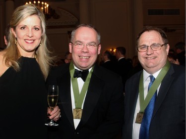Susan Smith, Bluesky Strategy Group, with Paul Wells, last year's winner of the Shaughnessy Cohen Prize, and fellow author Mark Bourrie at the Politics and the Pen gala dinner held at the Fairmont Chateau Laurier on Wednesday, March 11, 2015.