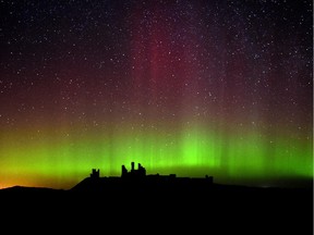 The aurora borealis, or northern lights as they are commonly known are photographed, over Dunstanburgh Castle, in Northumberland, England, on Tuesday.