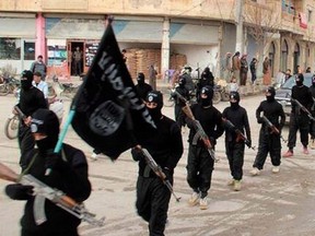 This undated file image posted on a militant website on Tuesday, Jan. 14, 2014 shows fighters from the al-Qaida linked Islamic State of Iraq and the Levant (ISIL) marching in Raqqa, Syria.