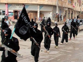 Fighters from theIslamic State of Iraq and the Levant (ISIL) march in Raqqa, Syria.