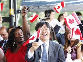 New Canadians celebrate after taking the oath of citizenship during a ceremony in Toronto, once the destination for nearly half of new immigrants to Canada and still the largest magnet for newcomers.