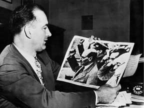 In this file photo, U.S. Sen. Joseph McCarthy holds a picture showing Clement Richard Attlee, former British statesman and prime minister (1945-1951) making a communist salute during the Spanish civil war. John Parnell Thomas and McCarthy instigated an anti-communist witchhunt campaign in the early 1950s, a period known as McCarthyism.