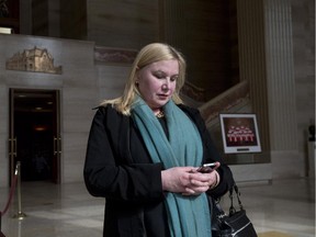 Wendy Cukier reads a message on her smart phone as she stands in the foyer of the Supreme Court of Canada in Ottawa, Friday March 27, 2015. Cukier is president of the Coalition for Gun Control.
