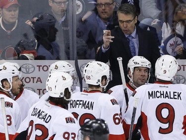 Ottawa Senators head coach Dave Cameron talks to his team during a break in first period NHL action.