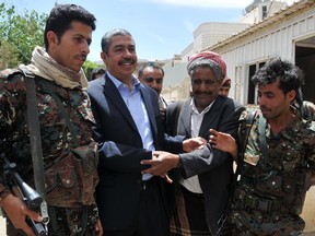 Former Yemeni prime minister Khalid Bahah, second from left, is greeted by supporters outside his house in Sanaa on March 16, 2015, after Huthi militia agreed to free him and all his cabinet ministers after nearly two months of house arrest.