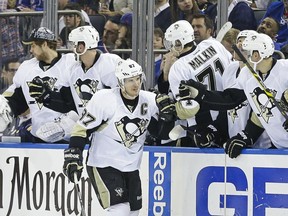 Pittsburgh Penguins' Sidney Crosby (87) celebrates with teammates after scoring a goal during the second period of Game 2 against the New York Rangers in the first round of the NHL hockey Stanley Cup playoffs Saturday, April 18, 2015, in New York. (AP Photo/Frank Franklin II)