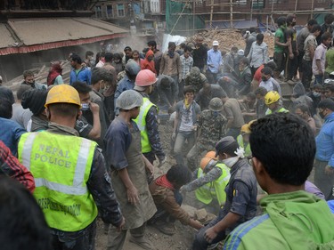 People clear rubble in Kathmandu's Durbar Square, a UNESCO World Heritage Site that was severely damaged by an earthquake on April 25, 2015. A massive 7.8 magnitude earthquake killed hundreds of people April 25 as it ripped through large parts of Nepal, toppling office blocks and towers in Kathmandu and triggering a deadly avalanche that hit Everest base camp. AFP PHOTO / PRAKASH MATHEMAPRAKASH MATHEMA/AFP/Getty Images