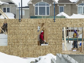 Cold weather in March failed to slow down home sales for the month, although starts were down. Here, workers are busy at Minto’s Arcadia project in Kanata.
