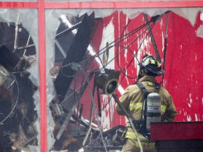 Ottawa Fire continue to put out hot spots. An overnight fire destroyed a commercial block at the intersection of Bank and 5th Ave in the Glebe.  (Pat McGrath / Ottawa Citizen)