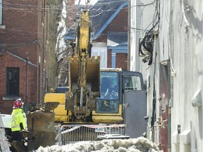 Heavy equipment has been brought in to help stabilize the ruined structure at Bank and Fifth to free space for investigators.