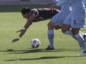 The Ottawa Fury's Paulo Junior is tripped up during play against Minnesota United FC at TD Place.