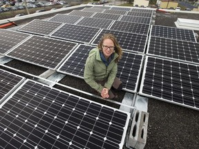 Janice Ashworth, operations manager with OREC with a portion of the solar panel instillation. On Earth Day students of École secondaire catholique Franco Cité learned about climate change and rooftop solar energy. A 150 kilowatt solar array on the roof of the school with a partnership between the Conseil des écoles catholiques du Centre-Est (CECCE) and the Ottawa Renewable Energy Co-op (OREC). The project will produce 240 megawatt hours of power annually at a cost of $1 million and will generate $3.5 million in revenues.