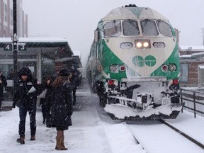 A commuter wait to board a GO train in Oakville, Ont. on Thursday December 11, 2014.